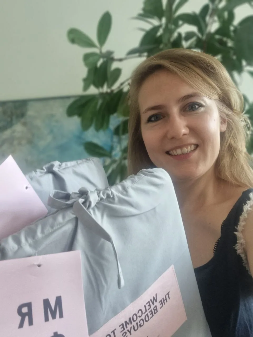 Smiling customer holding MRFS Store bed linen