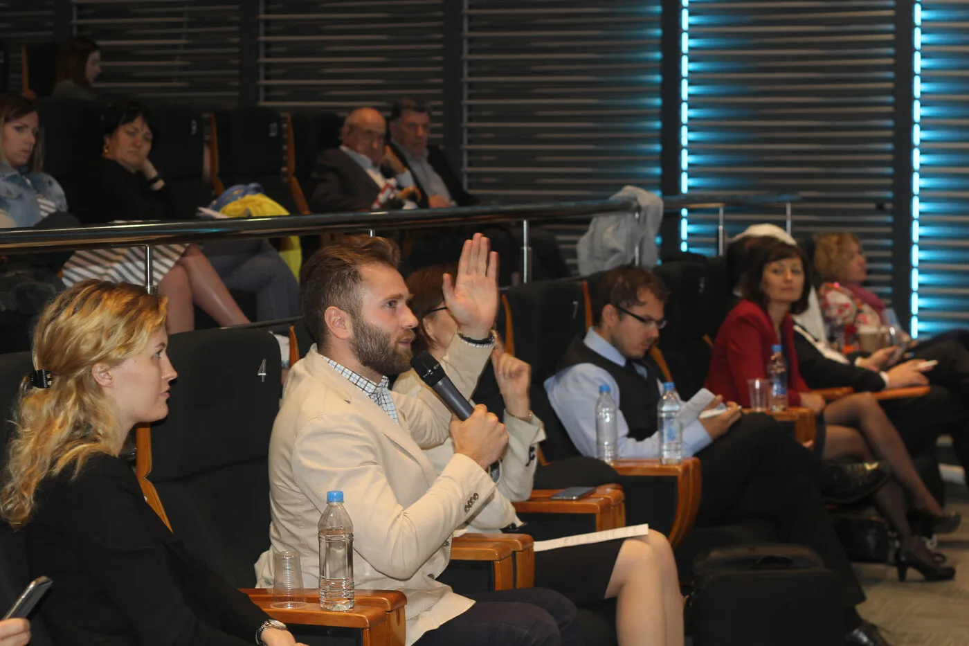Participant asking a question during a seminar