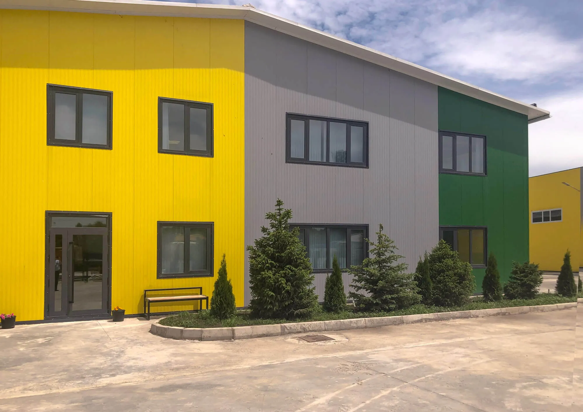 Building clad in coloured sandwich panels